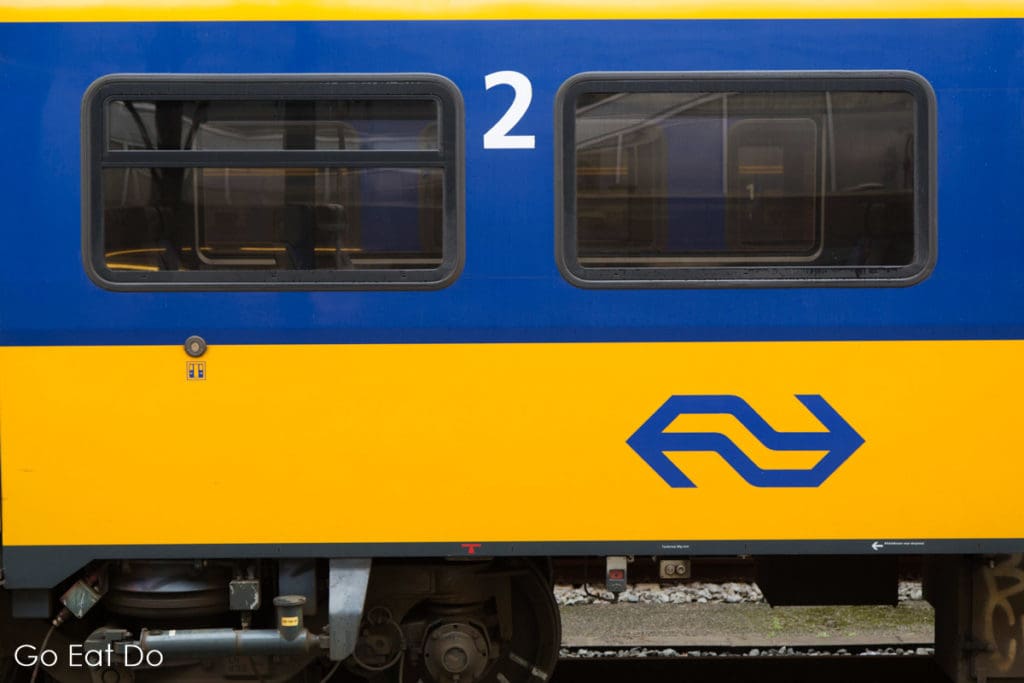 Train in the blue and yellow livery of the Nederlandse Spoorwegen, Dutch Railways.