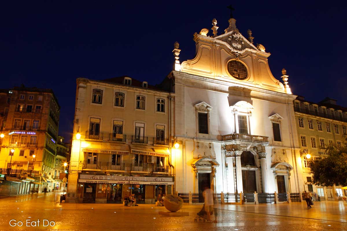 Church of Sao Domingos and illuminated facades of buildings in the Baixa district of Lisbon.