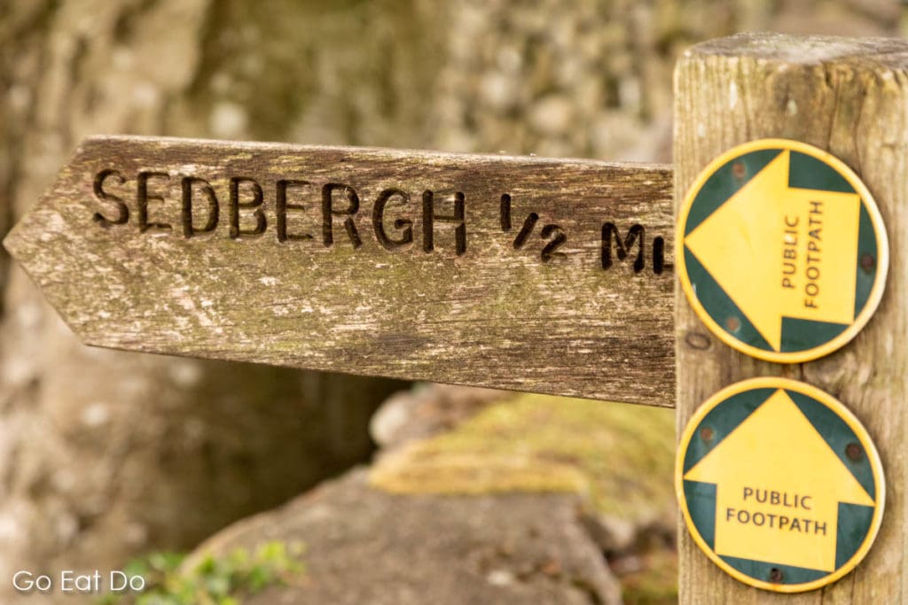 Public footpath pointing towards the town of Sedbergh in the Yorkshire Dales National Park.