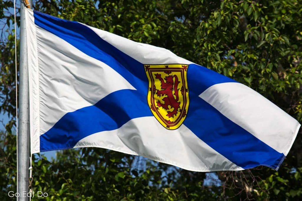 Canadian lumberjack Darren Hudson operates the Wild Axe Lumberjack Axeperience in Nova Scotia, whose provincial flag is shown here.