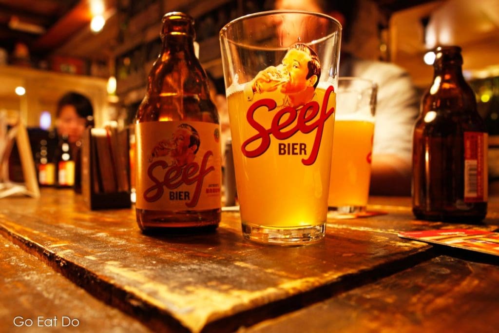 Bottles and glasses of Seef beer at a bar in Antwerp, Belgium, seefbier was a Belgian ale popular before World War One and revived in the 21st century.