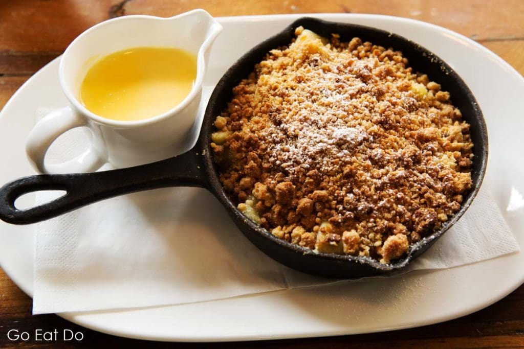 Crumble and custard, one of the desserts served at The Parcel Yard pub at King's Cross in London.