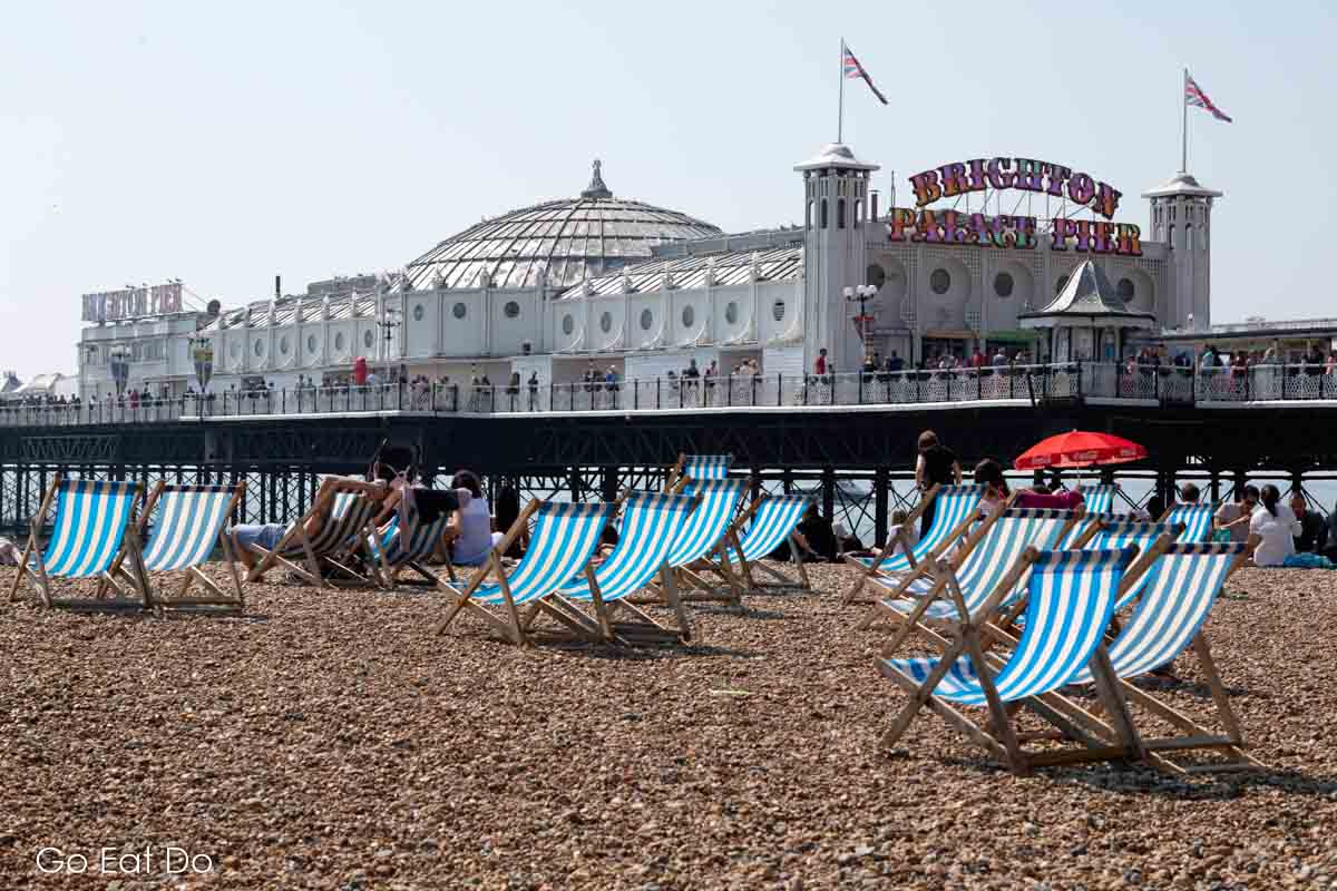 People bathing on Brighton Beach, one of the popular places to visit in East Sussex.