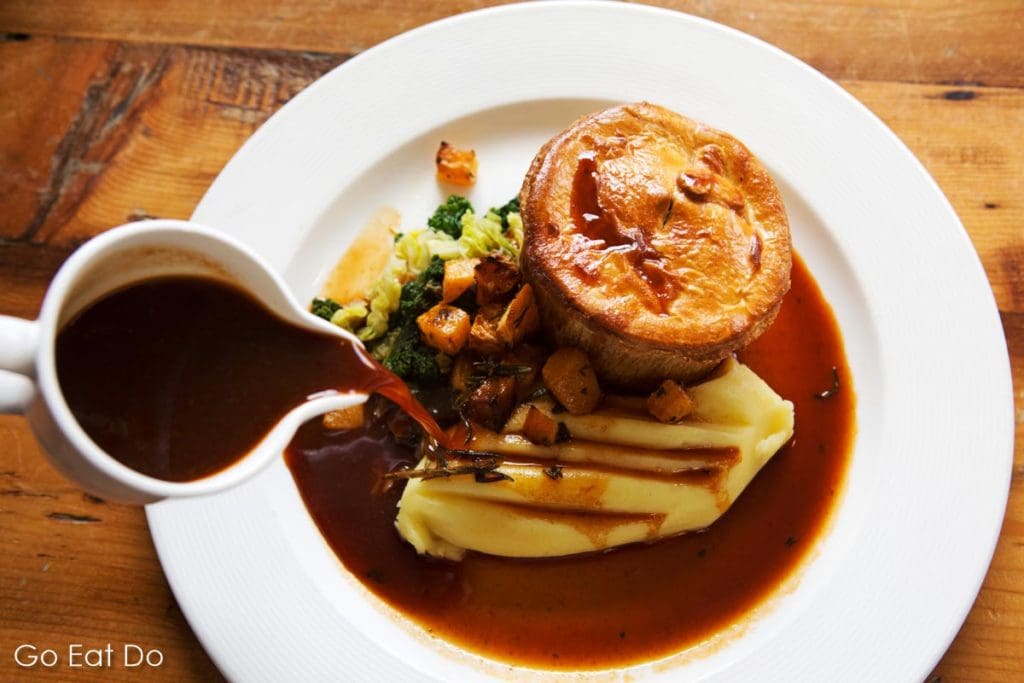 Venison pie served with mash and gravy at The Parcel Yard in King's Cross Station, London
