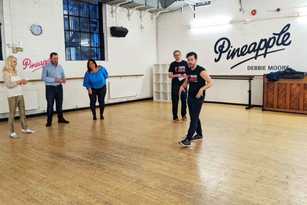 Livio and Adam from Theatre Workout welcoming West End Star for a Day participants to Pineapple Dance Studios in central London.