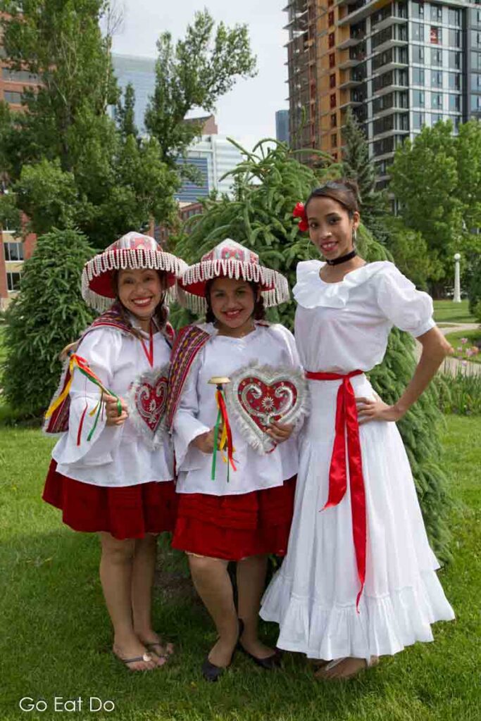 Women of Peruvian heritage attending Ccalgary's Lilac Festival on 4th Street.