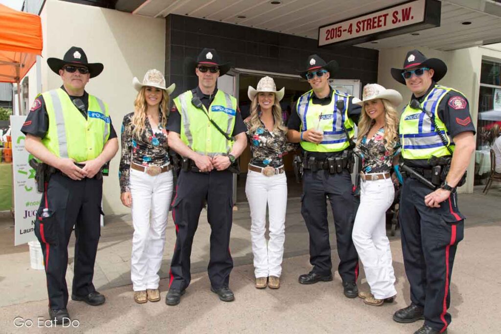 Police officers and Calgary Stampede Royalty at the Calgary Lilac Festival on 4th Street.