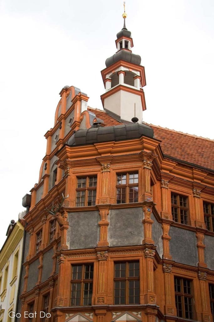 The ornate, red facade of the Schoenhaus, one of the many historic buildings in central Goerlitz in Saxony, Germany.
