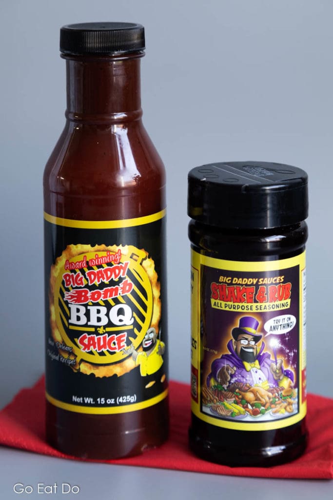 A bottle of Big Daddy Bomb BBQ Sauce and a jar of Big Daddy Sauces Shake and Rub All Purpose Seasoning.