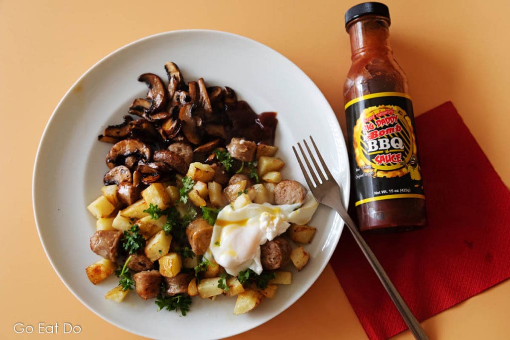 Big Daddy Sauces Bomb BBQ sauce served with tater tots, sausage and poached egg for breakfast