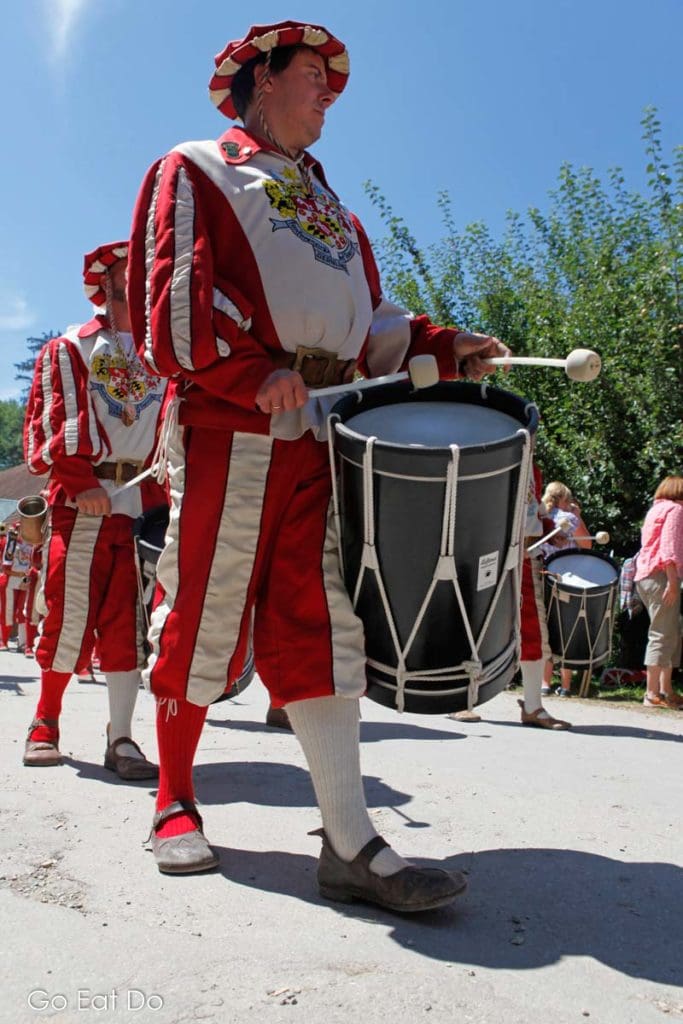 Drummers in livery marching through the medieval village at Kaltenberg Castle.