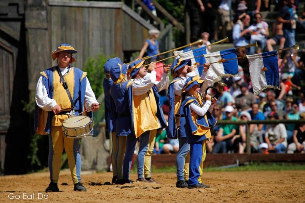 Fanfare by musicians in medieval-style livery.
