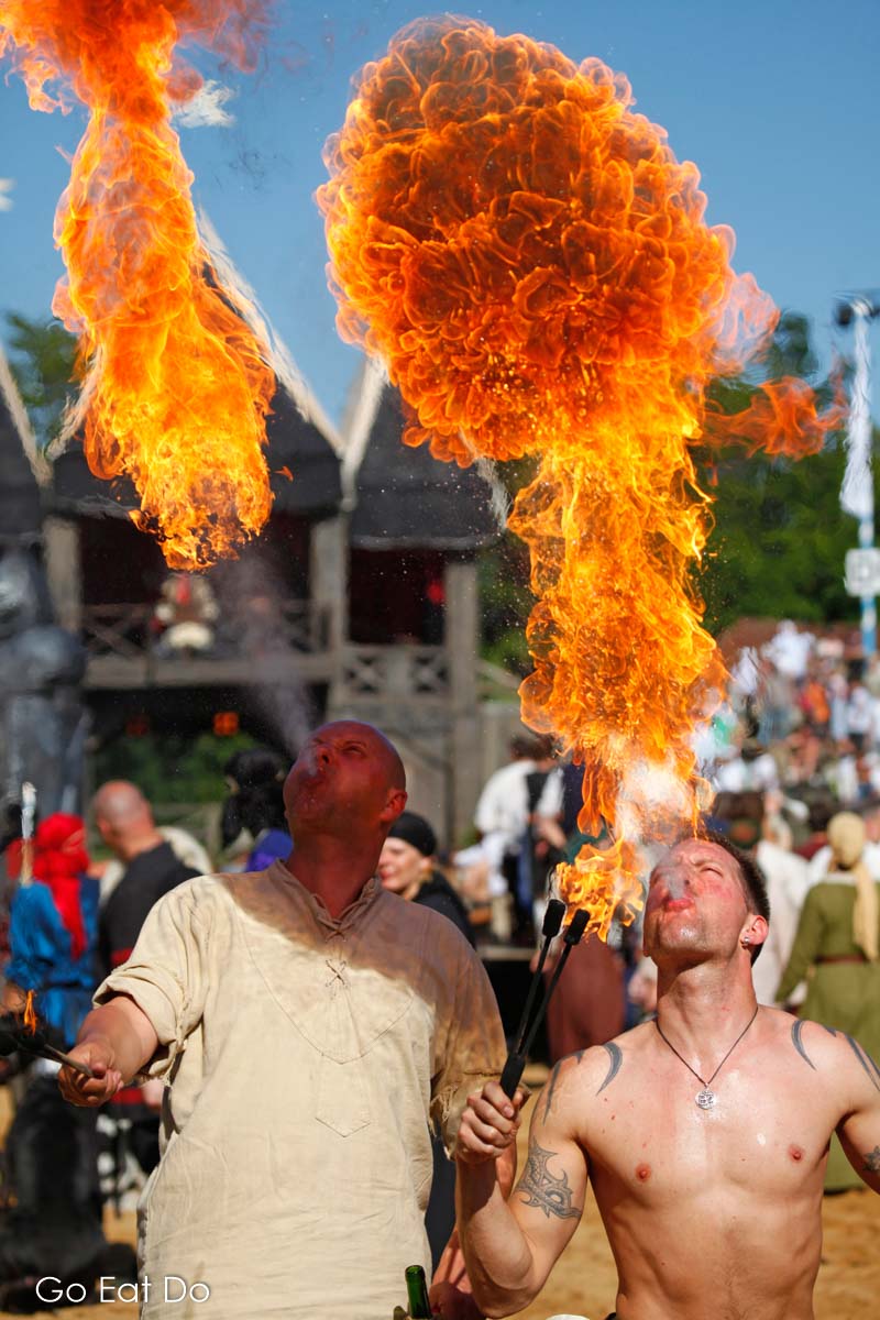 Fire eaters billow balls of flame in the area during the procession ahead of the tournament show at the Kalternberg Ritterturnier in Bavaria.