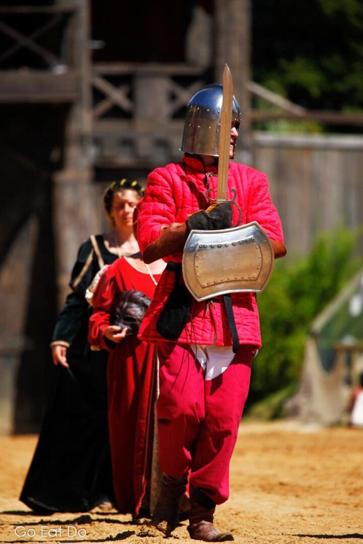 Warrior with a shield, helmet and sword during the medieval reenactment.