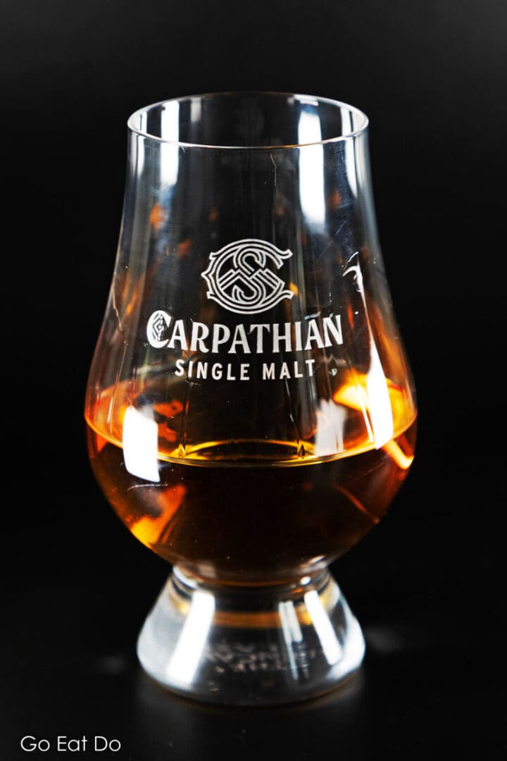 A whisky tasting glass bearing the Carpathian Single Malt's branding.