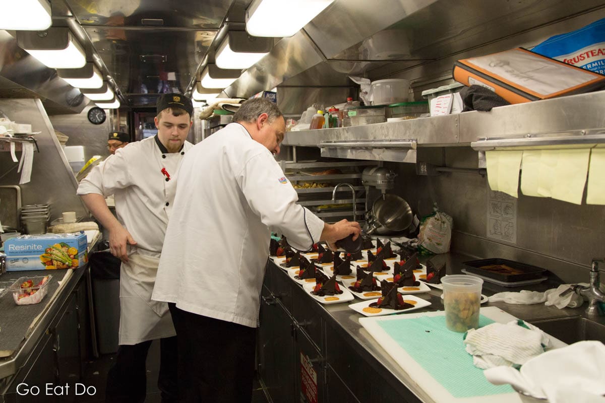 Chefs preparing food on the Rocky Mountaineer train service in Canada.