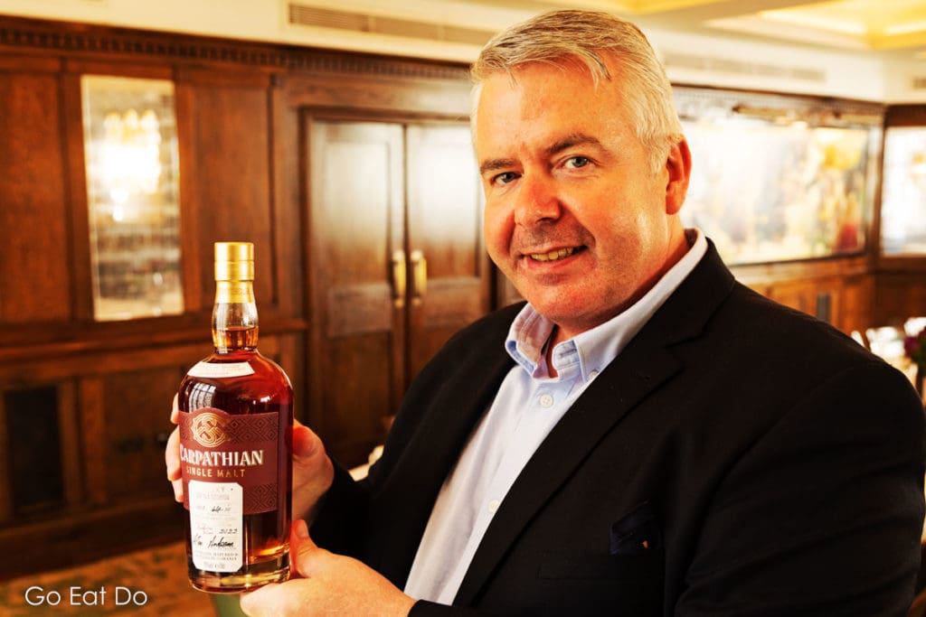Master distiller Allan Anderson with a bottle of Carpathian Single Malt whisky from Romania.