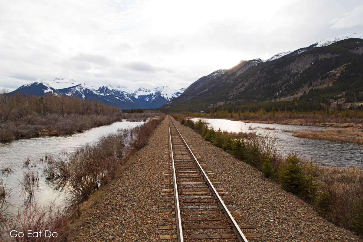 Railway track running towards the Canadian Rockies near Banff in Alberta, Canada.