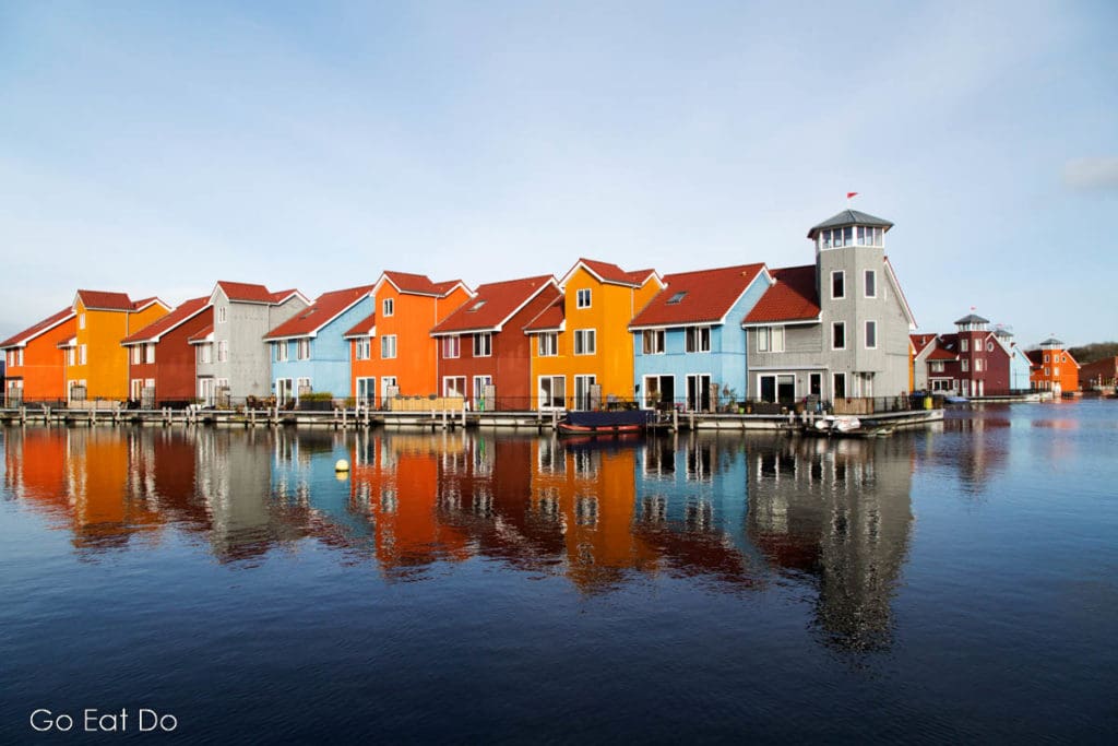 Travel by NS trains means an opportunity to enjoy colourfil scenes such as these colourful houses at the Reitdiephaven (Reitdiep Marina) in Groningen.