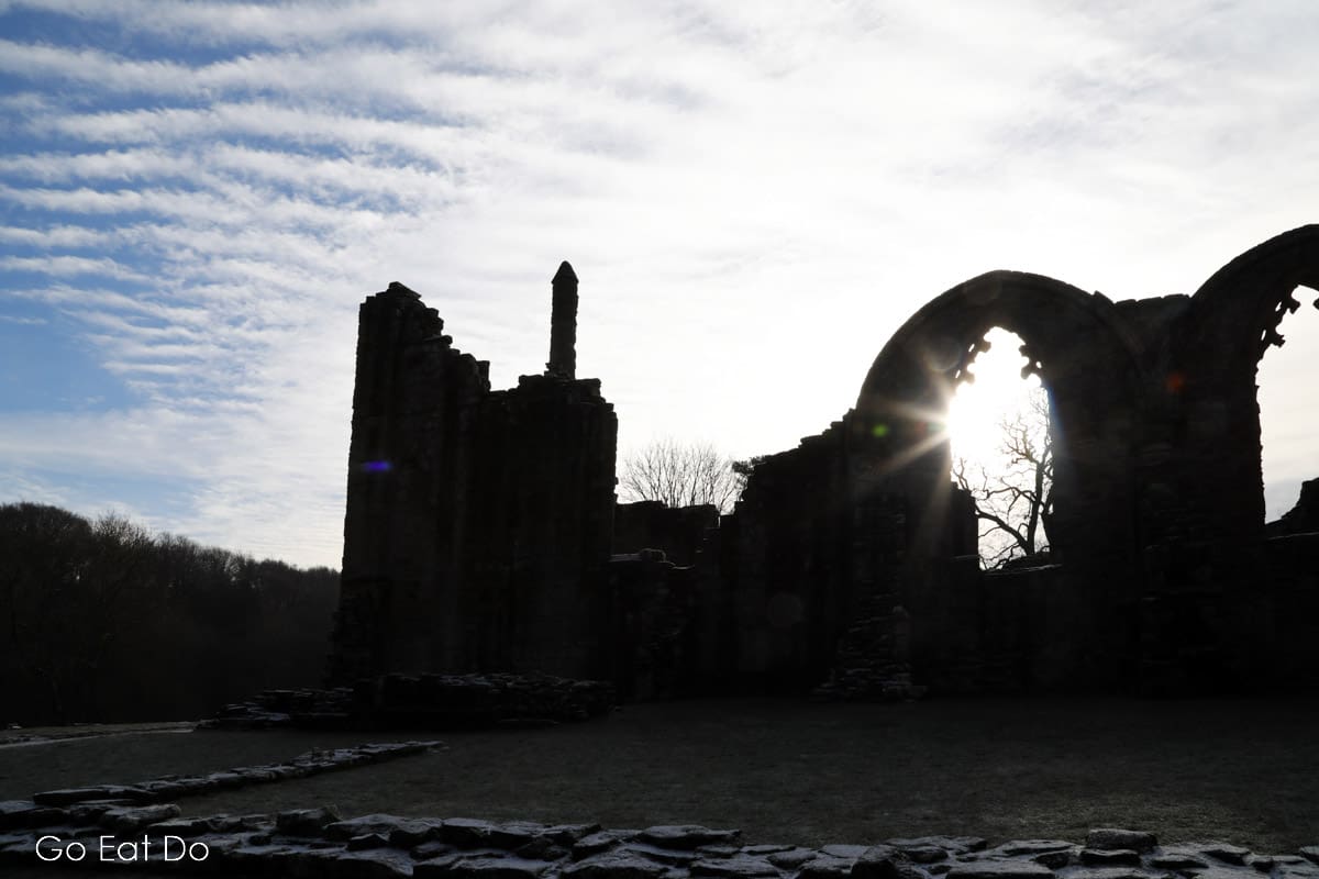 Sun shines through one of the arches of Finchale Priory, one of many historic places of interest in County Durham.