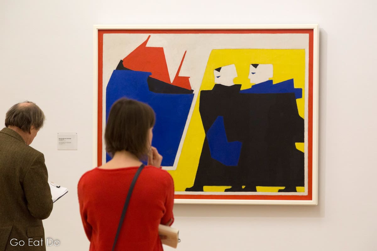 People view an artwork by Dutch artist Bart van der Leck, an influential member of De Stijl.
