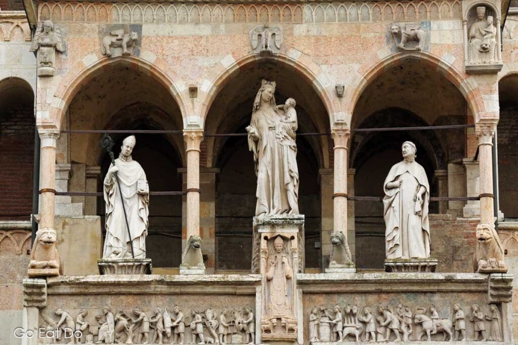 Sculptures on the loggia of Cremona Cathedral in Cremona, Italy. The figures are on the cathedral's Romanesque facade, dating from 1491.
