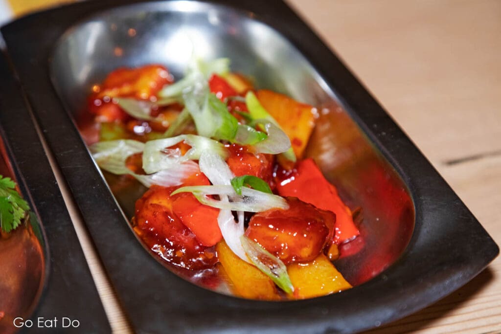 Dosa Kitchen's Chilli Paneer served with onions, peppers and chilli paste.
