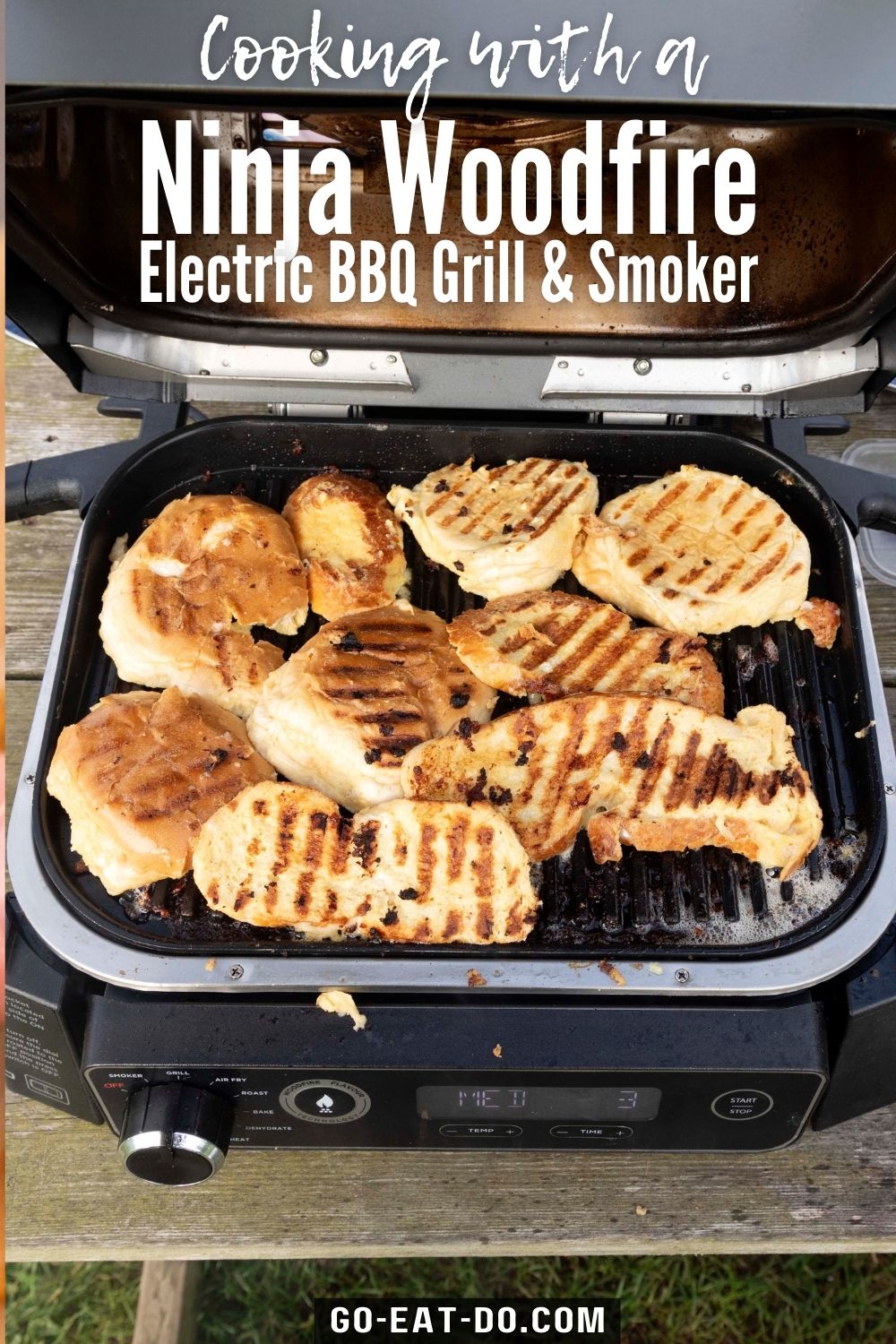 https://go-eat-do.com/wp-content/uploads/2023/09/pinterest-pin-for-go-eat-dos-blog-post-about-cooking-with-a-ninja-woodfire-outdoor-grill-the-ninja-woodfire-electric-bbq-grill-smoker.jpg