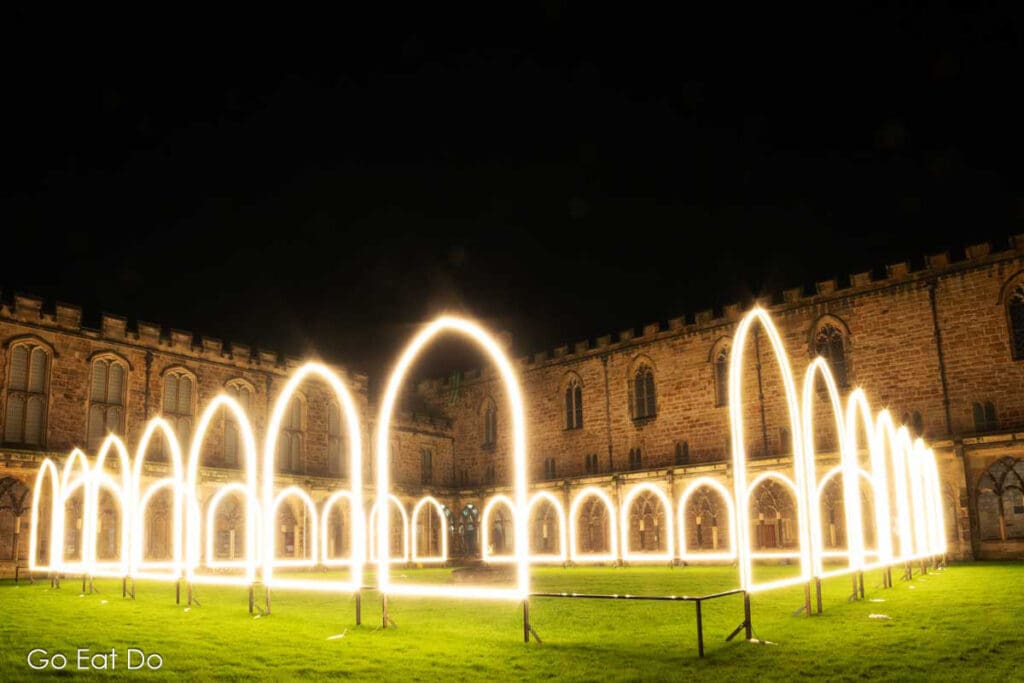 Illuminated arches form Adam Frenlin's Inner Cloister at Lumiere Durham in 2023.