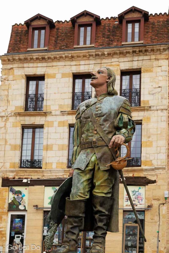 Statue of Cyrano de Bergerac looking up at his beloved Roxanne in the city of Bergerac.